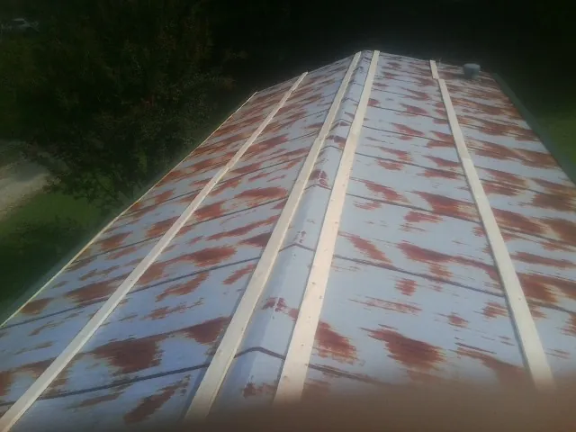 Rusted metal roof panels with new wood purlins before replacement — Storm Damage Roof Repair in Thornwood by Roofing Brothers